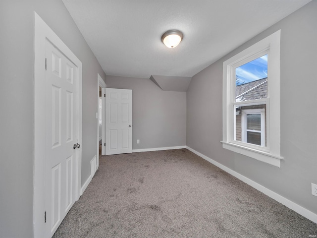 additional living space with lofted ceiling and carpet floors