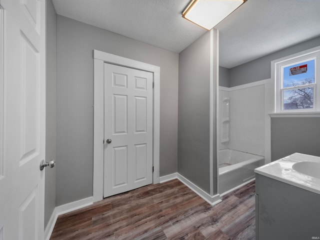 bathroom with vanity, wood-type flooring, and bathing tub / shower combination