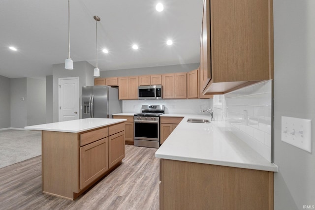 kitchen featuring a kitchen island, decorative light fixtures, sink, stainless steel appliances, and light brown cabinets