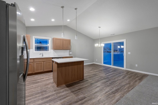 kitchen featuring a kitchen island, appliances with stainless steel finishes, sink, dark hardwood / wood-style flooring, and hanging light fixtures