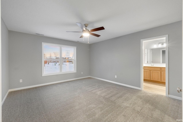 unfurnished bedroom featuring connected bathroom, ceiling fan, and carpet flooring