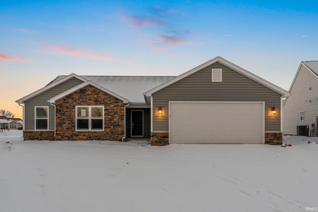 ranch-style house with cooling unit and a garage