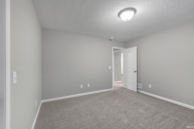 spare room with carpet floors and a textured ceiling