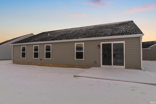 view of back house at dusk