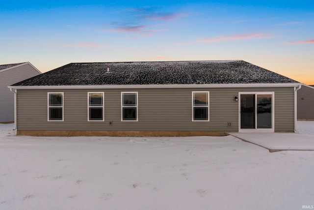 view of back house at dusk