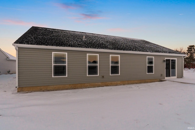 view of back house at dusk