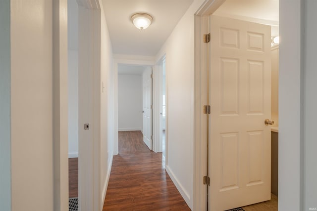 hallway with dark wood-type flooring