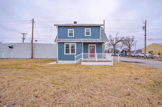 front of property featuring a front yard and covered porch