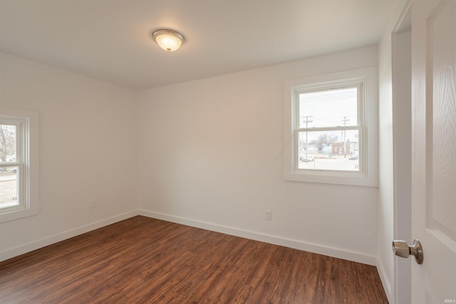 unfurnished room with dark wood-type flooring