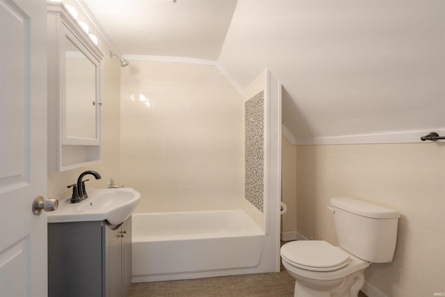 full bathroom featuring vanity, lofted ceiling, tile walls, and toilet