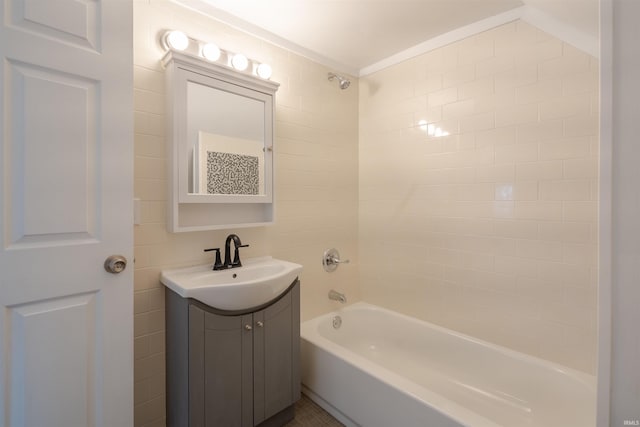 bathroom with tiled shower / bath combo and vanity