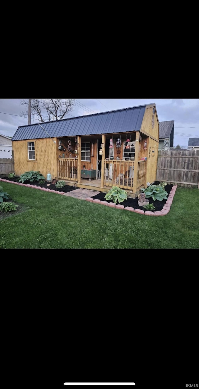 rear view of house featuring a yard