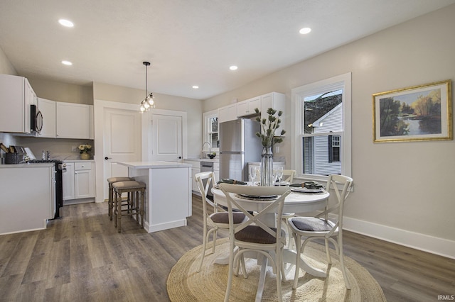 dining area with dark hardwood / wood-style floors