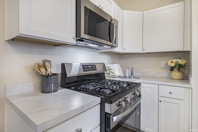 kitchen with white cabinetry and stainless steel appliances