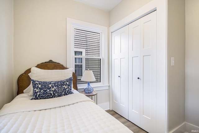 bedroom featuring wood-type flooring and a closet