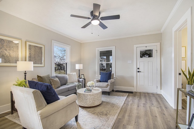 living room with crown molding, ceiling fan, and light hardwood / wood-style floors