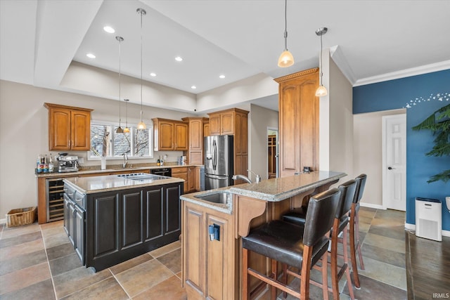 kitchen with stainless steel refrigerator with ice dispenser, a center island, and pendant lighting