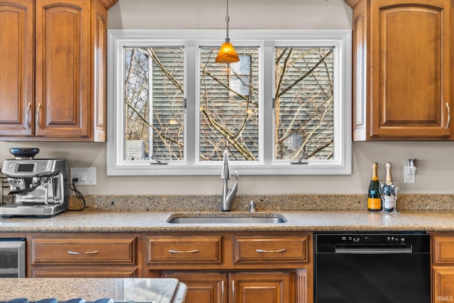 kitchen featuring light stone counters, sink, hanging light fixtures, and black dishwasher