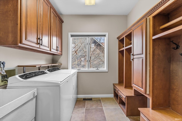 clothes washing area with separate washer and dryer, light tile patterned floors, cabinets, and sink