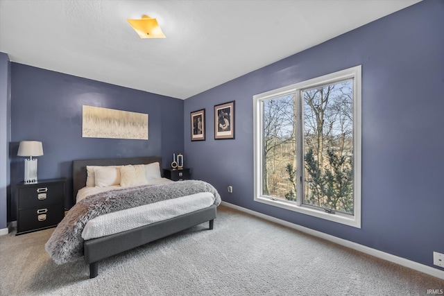 carpeted bedroom featuring multiple windows