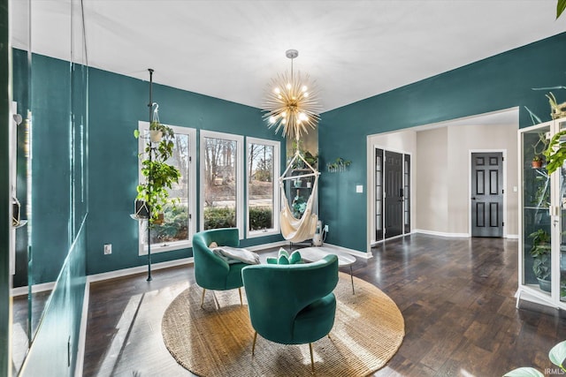 living area featuring dark wood-type flooring and a chandelier