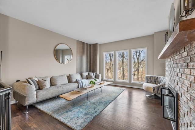 living room with dark wood-type flooring and a fireplace