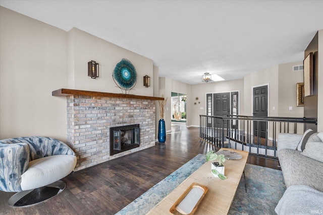 living room featuring dark hardwood / wood-style floors and a fireplace