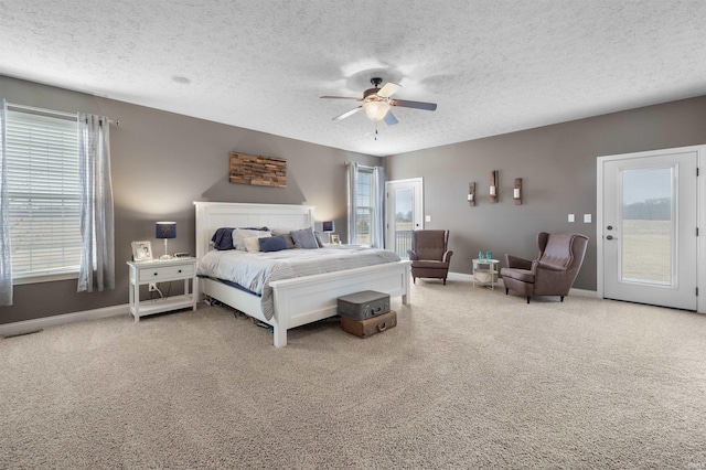 bedroom with ceiling fan, carpet flooring, access to exterior, and a textured ceiling