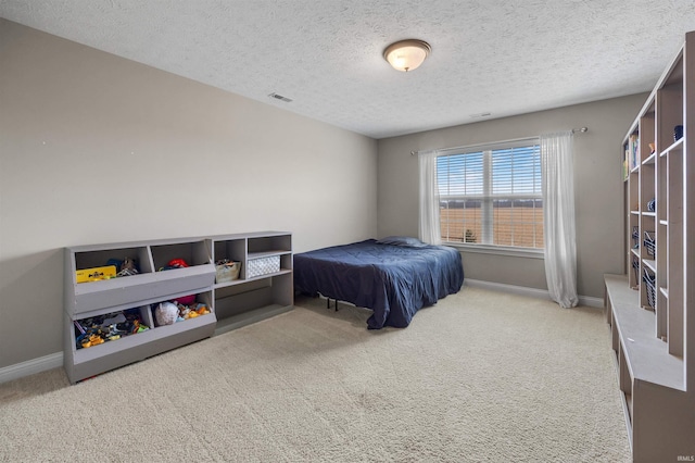 carpeted bedroom with a textured ceiling