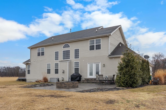 back of property featuring a yard and a patio area