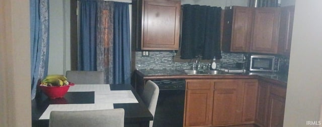 kitchen featuring sink, decorative backsplash, and dishwasher