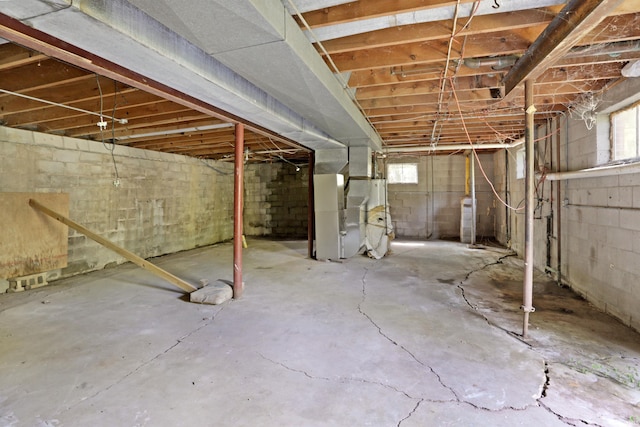 basement featuring heating unit and a wealth of natural light