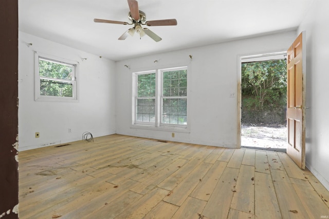 spare room with light hardwood / wood-style flooring and ceiling fan