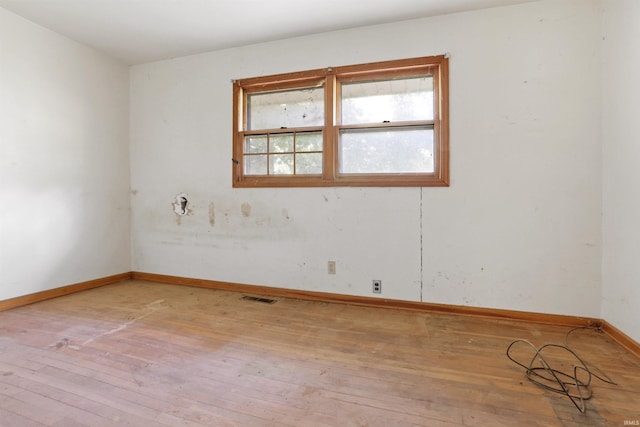 unfurnished room featuring hardwood / wood-style flooring