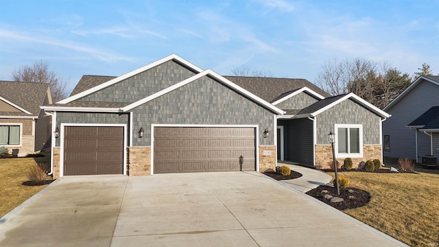 craftsman house with a garage and a front yard