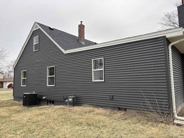 view of home's exterior featuring a lawn and central air condition unit