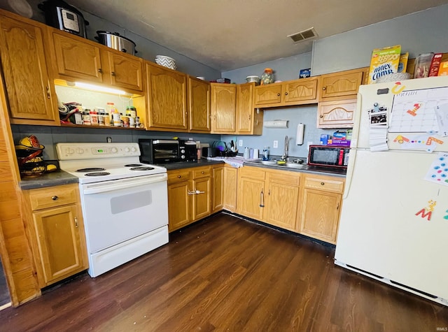 kitchen with dark hardwood / wood-style flooring, sink, and white appliances