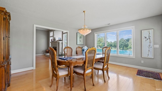 dining space featuring a chandelier and light hardwood / wood-style floors