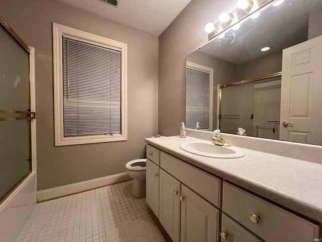 full bathroom with vanity, bath / shower combo with glass door, tile patterned floors, and toilet