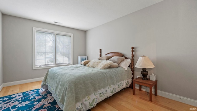 bedroom with hardwood / wood-style floors