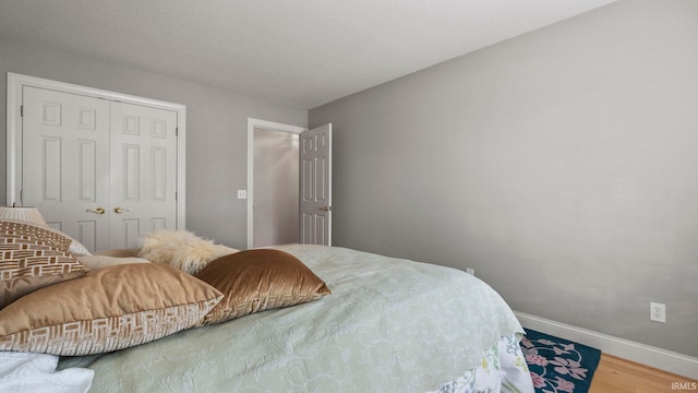 bedroom with hardwood / wood-style flooring and a closet