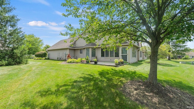 rear view of property featuring a yard