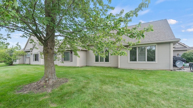 back of house featuring a lawn