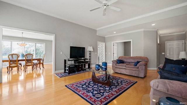 living room with ceiling fan, ornamental molding, and wood-type flooring