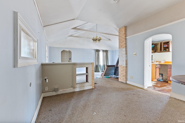 unfurnished living room featuring lofted ceiling, a notable chandelier, and carpet flooring