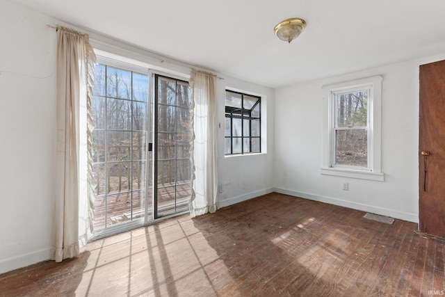 spare room with hardwood / wood-style floors