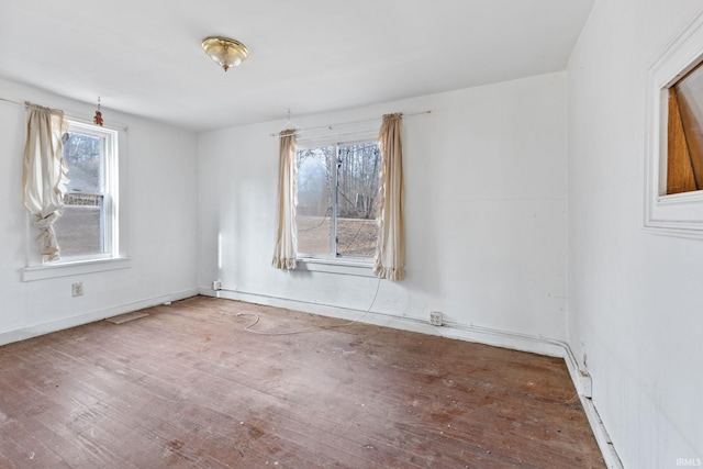 spare room featuring wood-type flooring