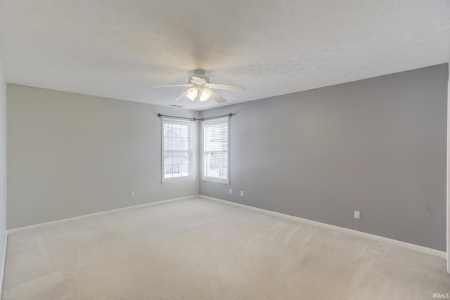 carpeted spare room with ceiling fan and a textured ceiling