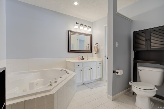 bathroom with tile patterned flooring, vanity, toilet, tiled tub, and a textured ceiling