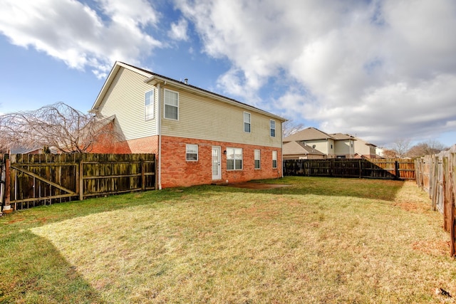 rear view of house featuring a lawn